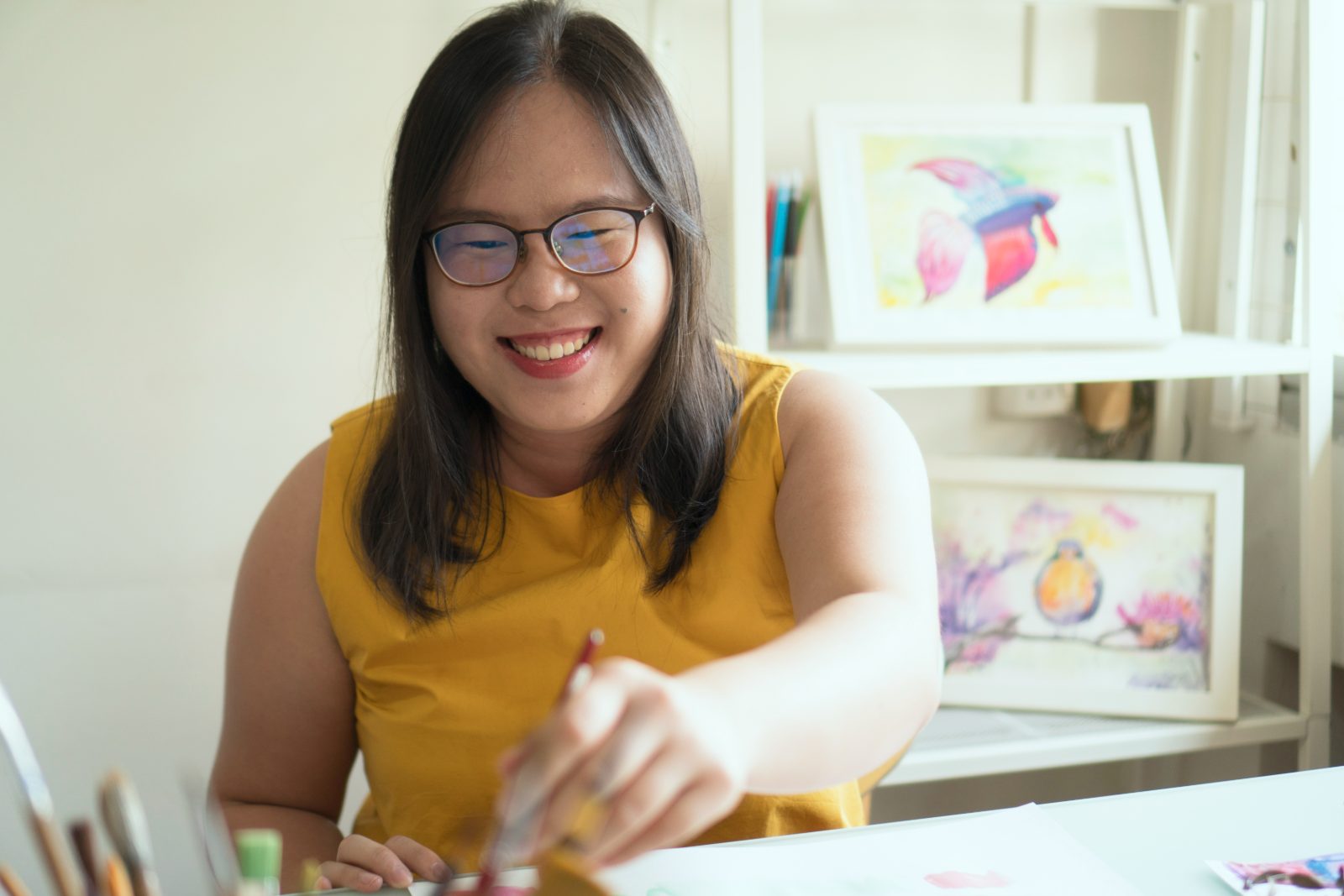 Sandy Jam, watercolour artist from Singapore, painting at her studio desk