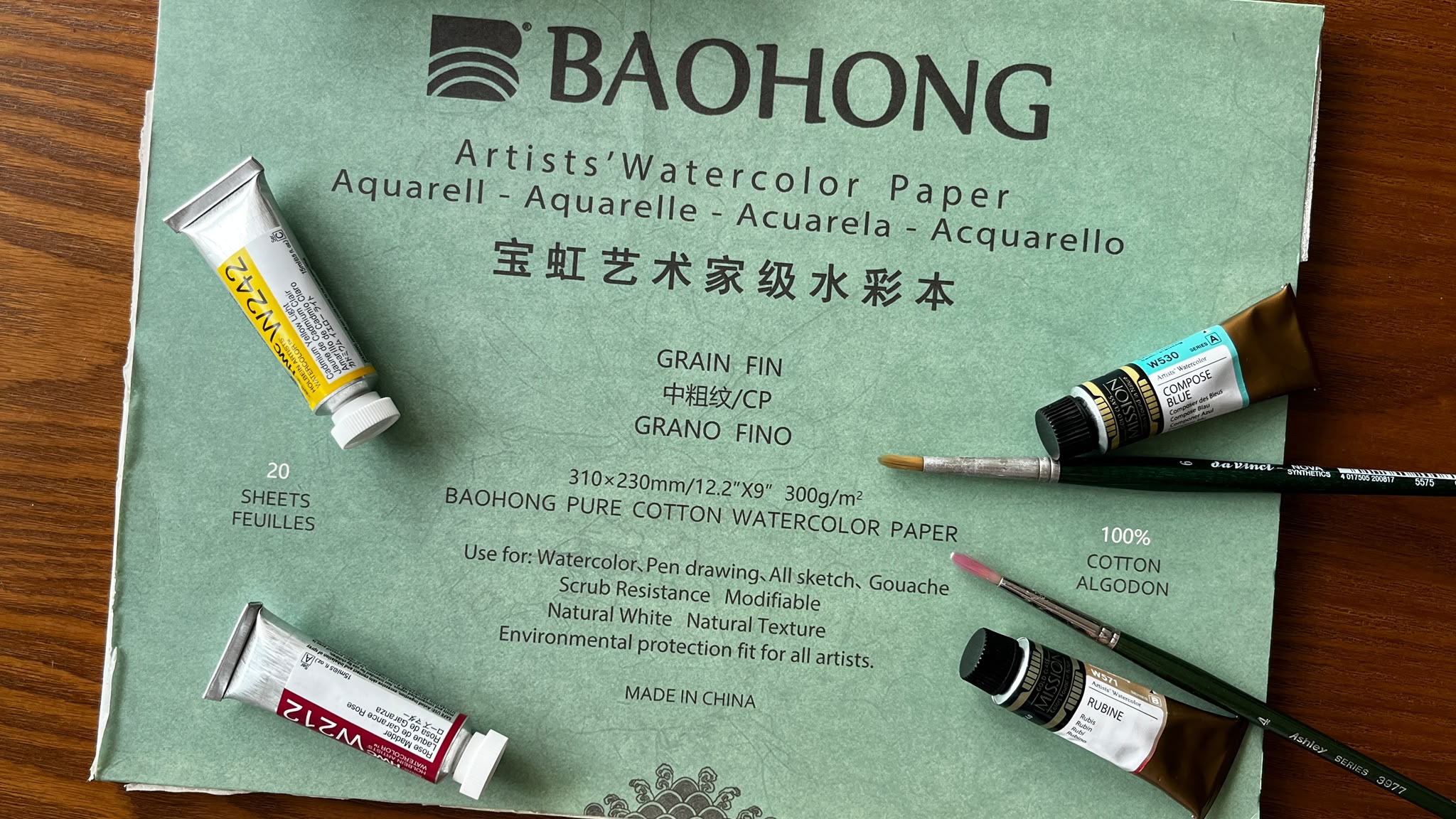 Flat-lay of watercolour supplies including Bao Hong watercolour paper
